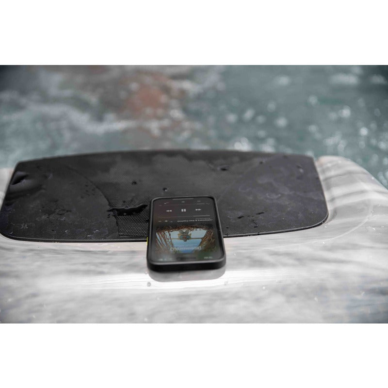 Smartphone on the Colombo whirlpool's integrated Bluetooth sound system - modern music control for a personalized spa experience.